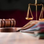 focus-on-hammer-group-of-files-on-judge-table-covered-with-dust-concept-of-pending-old-cases
