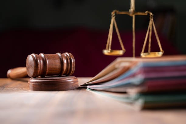 focus-on-hammer-group-of-files-on-judge-table-covered-with-dust-concept-of-pending-old-cases