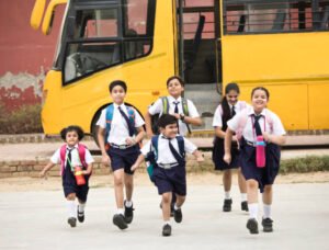 Schoolboys and schoolgirls walking of the school bus outdoor
